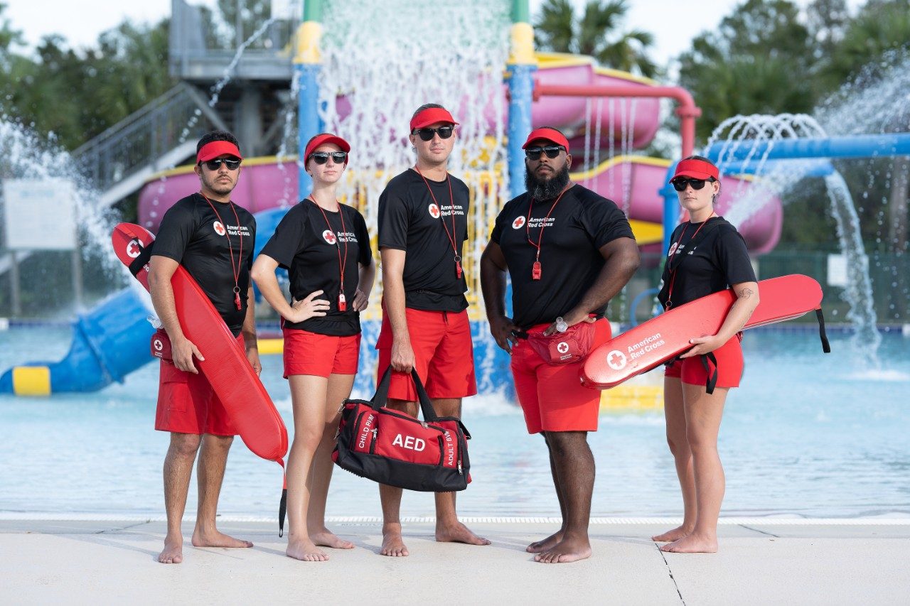 lifeguards standing in fron of a water park